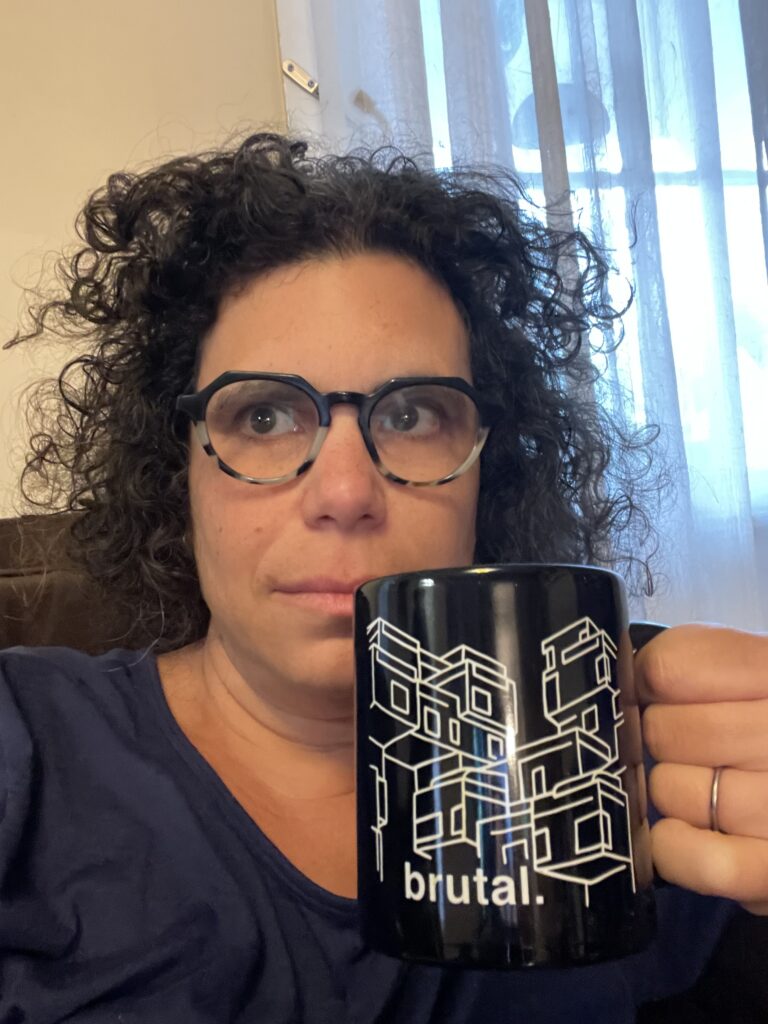 Photo of Andi holding a mug that shows Habitat 67